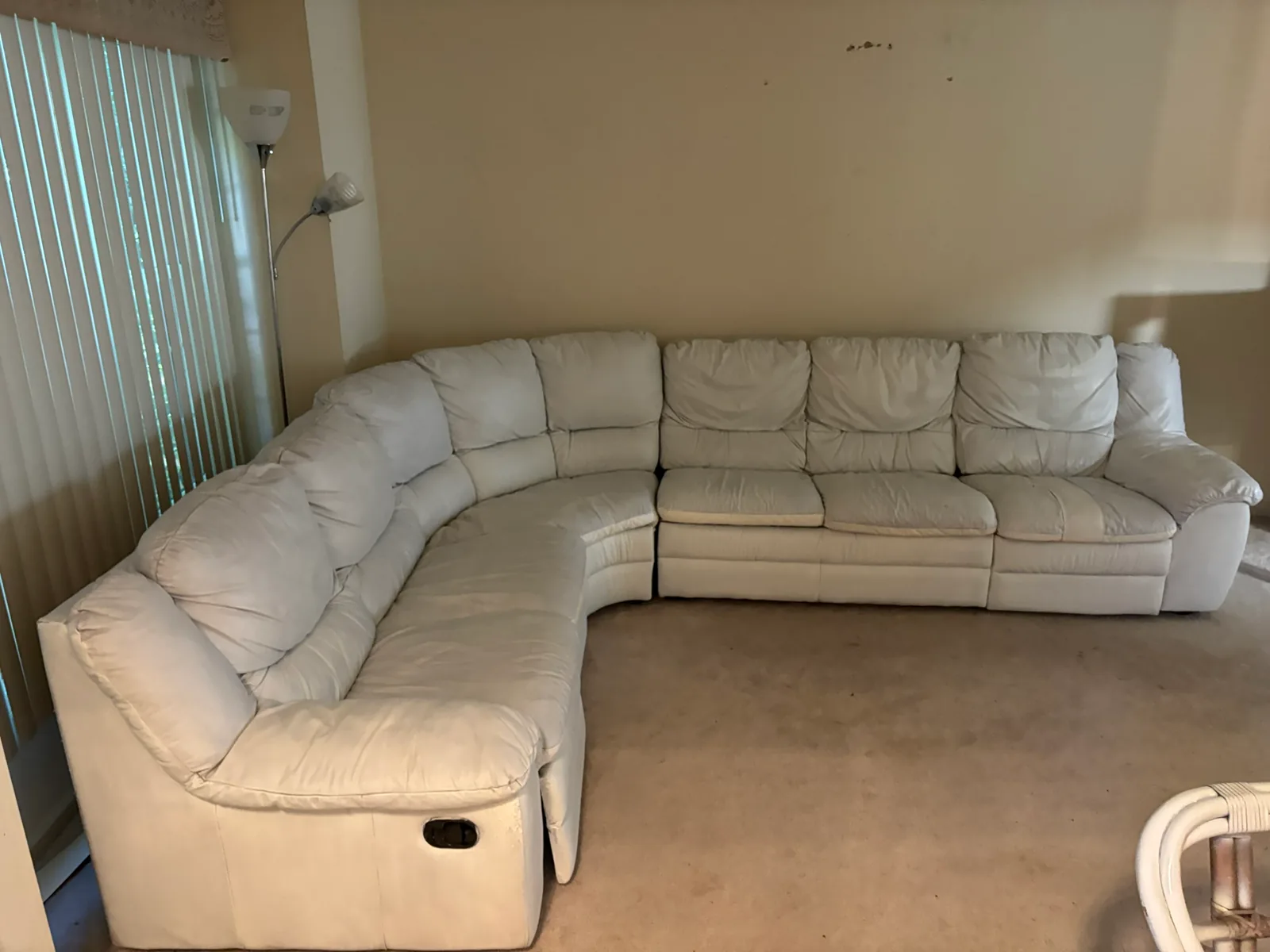 Cream sectional couch in a Novi living room before furniture removal